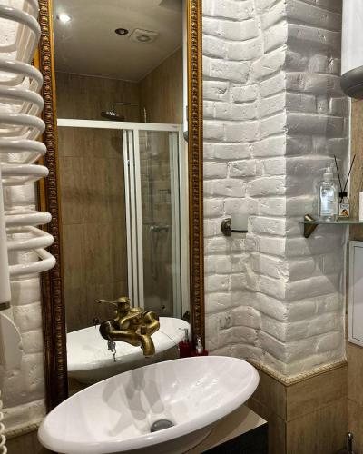 a bathroom with a sink and a mirror at VIP apartment 40 in Lviv