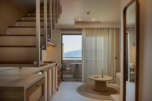 a kitchen with a staircase and a table in a room at Kelyfos Nafpaktos in Nafpaktos