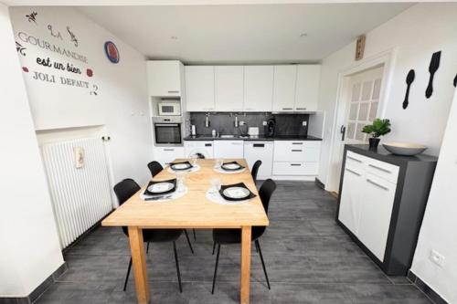 a kitchen with a wooden table and chairs at The Dutt's cocoon spacious and charming T3 in Duttlenheim
