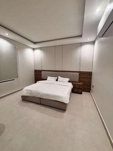 a bedroom with a bed and a projection screen at ايراد للشقق المفروشه in Dammam