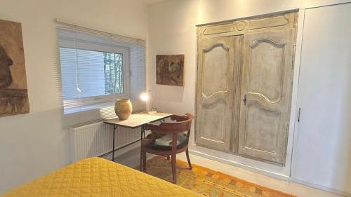 a bedroom with a desk and a large door at Le Duplex in Denicé