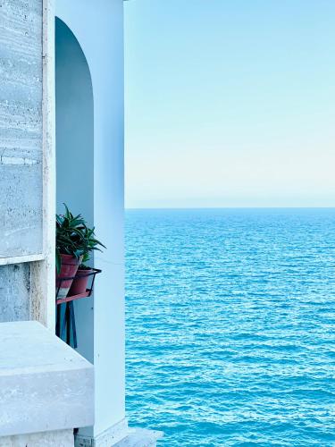 a view of the ocean from a balcony at Dimora Anvi - Relax Fronte Mare in Polignano a Mare