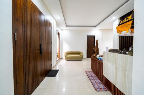 a hallway with a couch in a room at Dekade Living in Denpasar