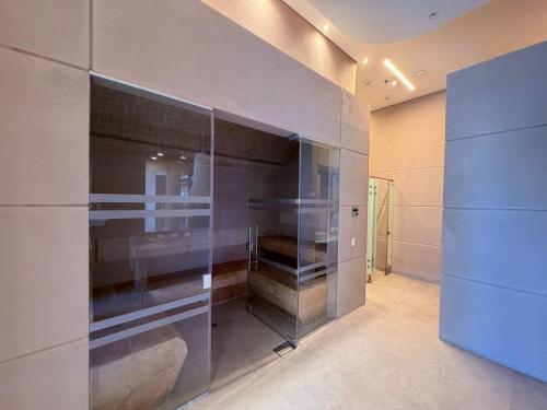a walk in closet with glass doors in a room at Edificio Reserva del Mar Bello Horizonte in Playa Bello Horizonte