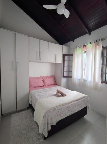 a bedroom with a bed with a stuffed animal on it at Apartamento Canasvieiras in Florianópolis