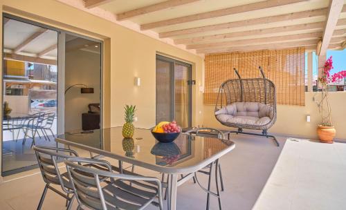 a dining room with a glass table and chairs at Irene Luxury Suite Roda in Roda