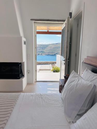 a bedroom with a bed and a view of the ocean at Gaia & Thalassa Villa Nafsika in Otziás