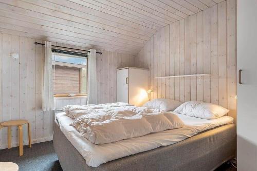 a bedroom with a large bed in a room at HA411-Hals-Junovej-13 in Hals