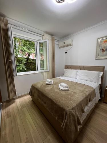 a bedroom with a bed with two towels on it at Lake Apartment in Sauk