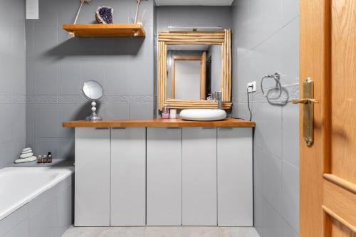 a bathroom with a mirror and a sink at Piso La Alondra in Fuengirola