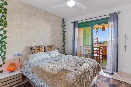 a bedroom with a large bed and a balcony at Piso La Alondra in Fuengirola