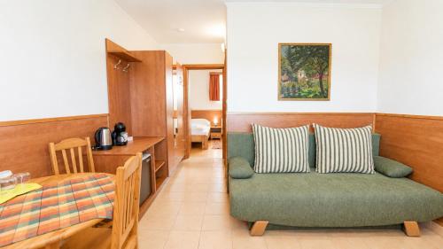 a living room with a couch and a table at Szabó Tanya Nyim in Nyim