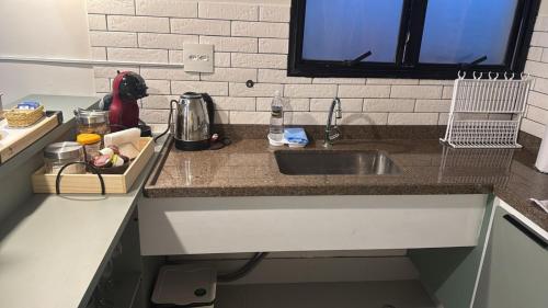 a kitchen with a sink and a counter top at Apartment 22 - Jundiaí in Jundiaí