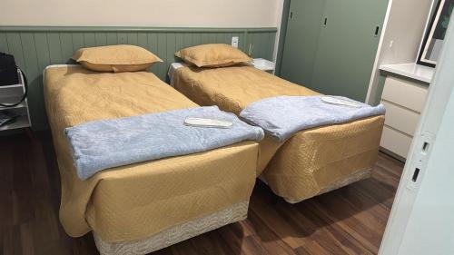 two beds sitting next to each other in a room at Apartment 22 - Jundiaí in Jundiaí