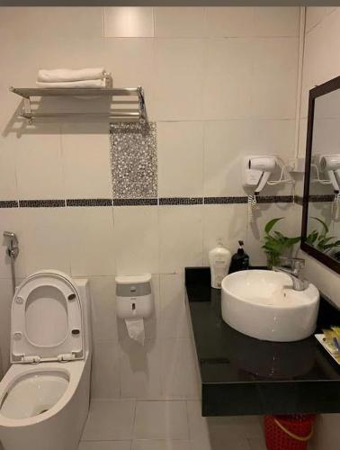 a bathroom with a toilet and a sink at G9 Home hotel in Hanoi