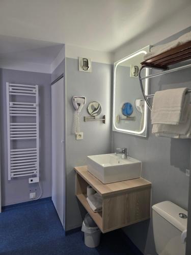 a bathroom with a sink and a mirror at La Vigie Vacances in Les Sables-d'Olonne
