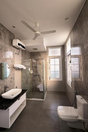 a bathroom with a shower and a toilet and a sink at IT City Luxe Homestay-Secure & Comfortable Stay in Mohali in Mohali