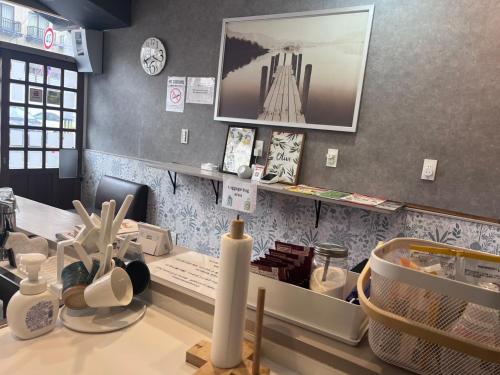 a counter in a store with a counter top with items at Cafe Sharehouse Kokoro Nest Kyoto in Kyoto