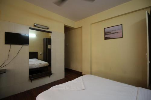a hotel room with two beds and a mirror at HOTEL GOLDEN PALACE PVT LTD in Mumbai