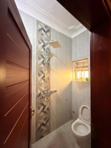 a bathroom with a toilet and a shower at Express Living & Wellness in Jinja
