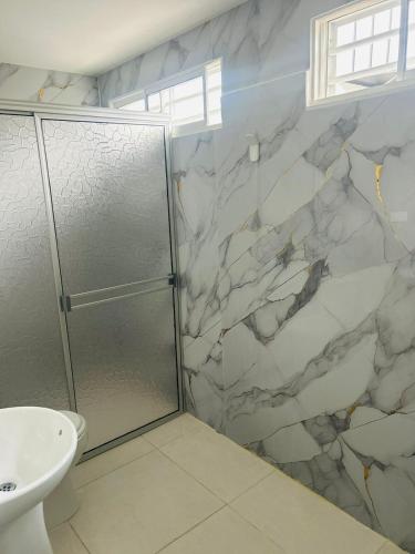 a bathroom with a shower and a sink at Hotel Galicia in Montería