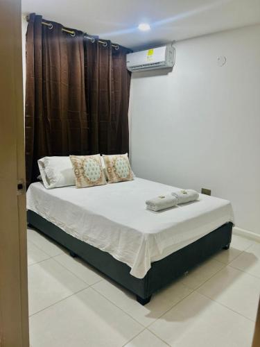 a bed in a room with avertisementatronatronstrationstrationstrationstration at Hotel Galicia in Montería