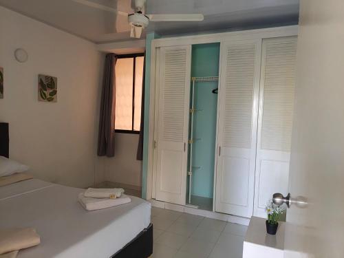 a bedroom with a bed and a glass door at VILLA IRIS in Santa Marta