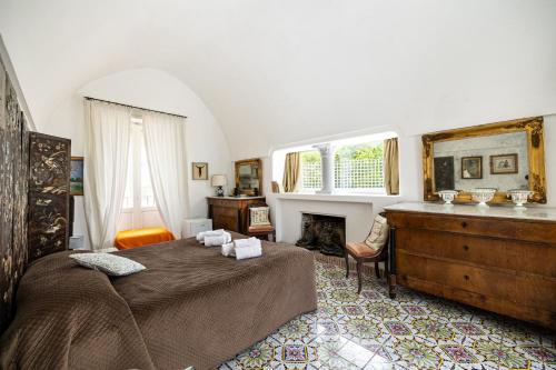 a bedroom with a bed and a fireplace at Casa Colette in Anacapri