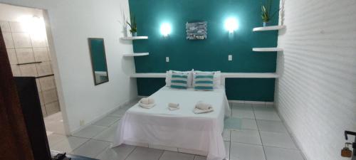 a room with a white table with two pillows on it at Pousada La Luna in Paracuru