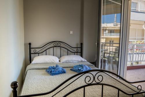 a bedroom with a bed with blue towels on it at Maria Apartments in Perea