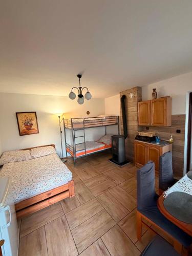 a bedroom with two bunk beds and a table at Noclegi u Lucyny in Chęciny