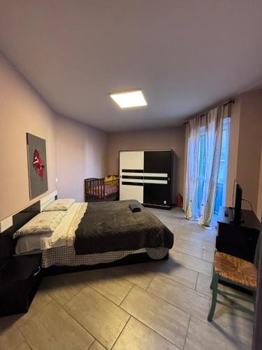 a bedroom with a bed and a flat screen tv at Le colline in corso Bra in Alba