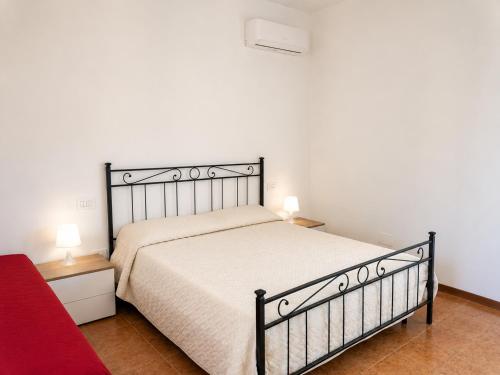 a bedroom with a bed and two lamps on tables at Via Milano 67 in Porto SantʼElpidio