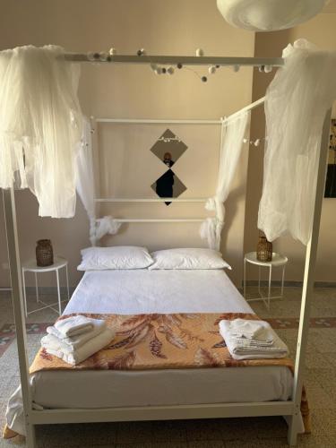 a bedroom with a bed with a white canopy at Scaramella room s in Salerno