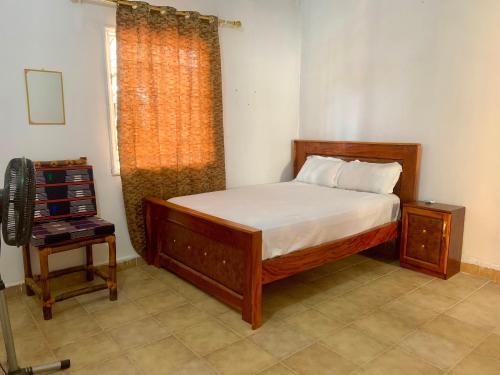 a bedroom with a bed and a window at Zen villa in Old Yundum