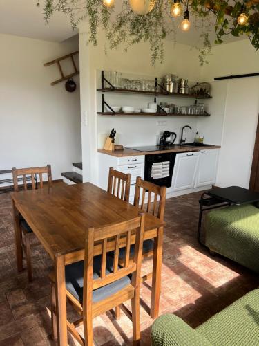 a dining room with a wooden table and chairs at Ubytování u Kotrbů in Suchdol nad Lužnicí