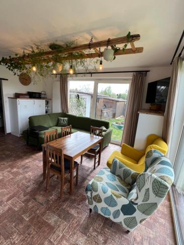 a living room with a table and a couch at Ubytování u Kotrbů in Suchdol nad Lužnicí