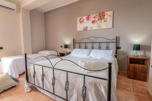 a bedroom with two beds and a painting on the wall at Hotel Ristorante L'Orizzonte in Le Castella