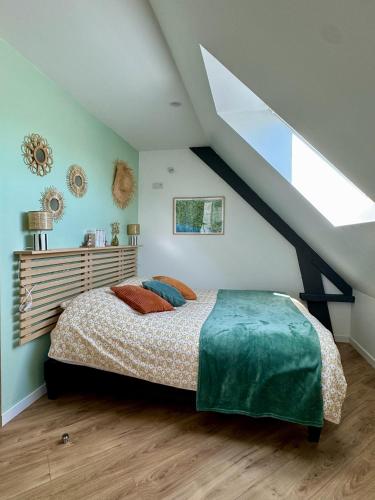 a bedroom with a large bed in a attic at Entre Terre & Sel in Clohars-Carnoët