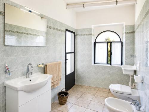 a bathroom with a sink and two toilets at Villa Amore in Cannobio