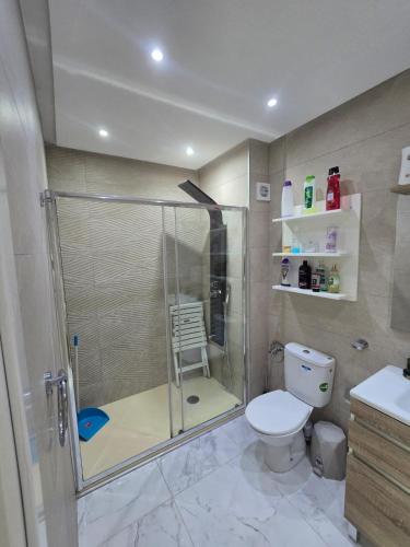 a bathroom with a shower and a toilet at pacotanjawi achakar in Tangier