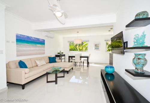 a living room with a couch and a table at The Sanctuary @ Los Corales in Punta Cana