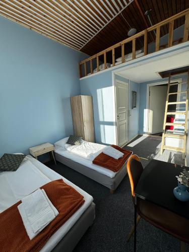 En eller flere senge i et værelse på NORD Motel & Restaurant
