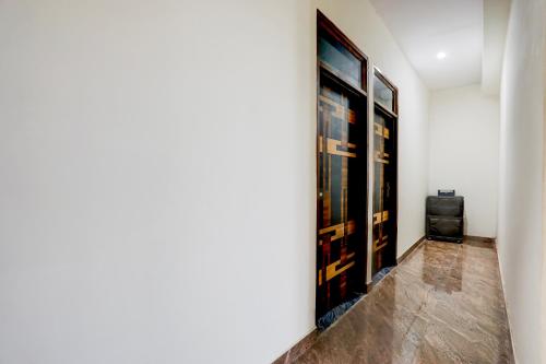 a hallway with a wall with paintings on it at Hotel O Kalka in Faridabad