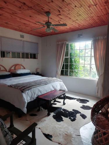 a bedroom with a bed and a large window at Good Vibes in Uniondale