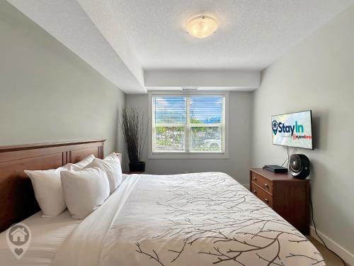 a bedroom with a bed and a window at Silver Rock by StayIn in Fernie