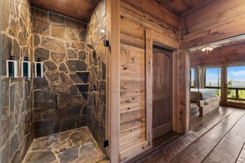 a bathroom with a stone wall at Sky's the Limit in Mineral Bluff