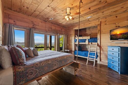 a bedroom with a bed and a bunk bed at Sky's the Limit in Mineral Bluff
