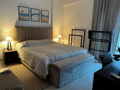 a bedroom with a bed and two tables and two lamps at Iconic Galaxy in Rajagiriya