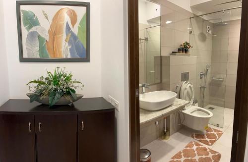 a bathroom with a sink and a toilet at Iconic Galaxy in Rajagiriya